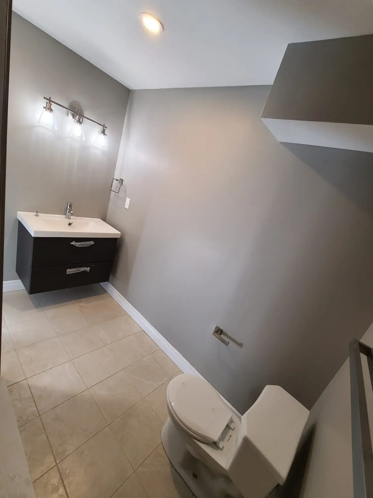 Finished bathroom renovation with polished tile, vanity, and fixtures