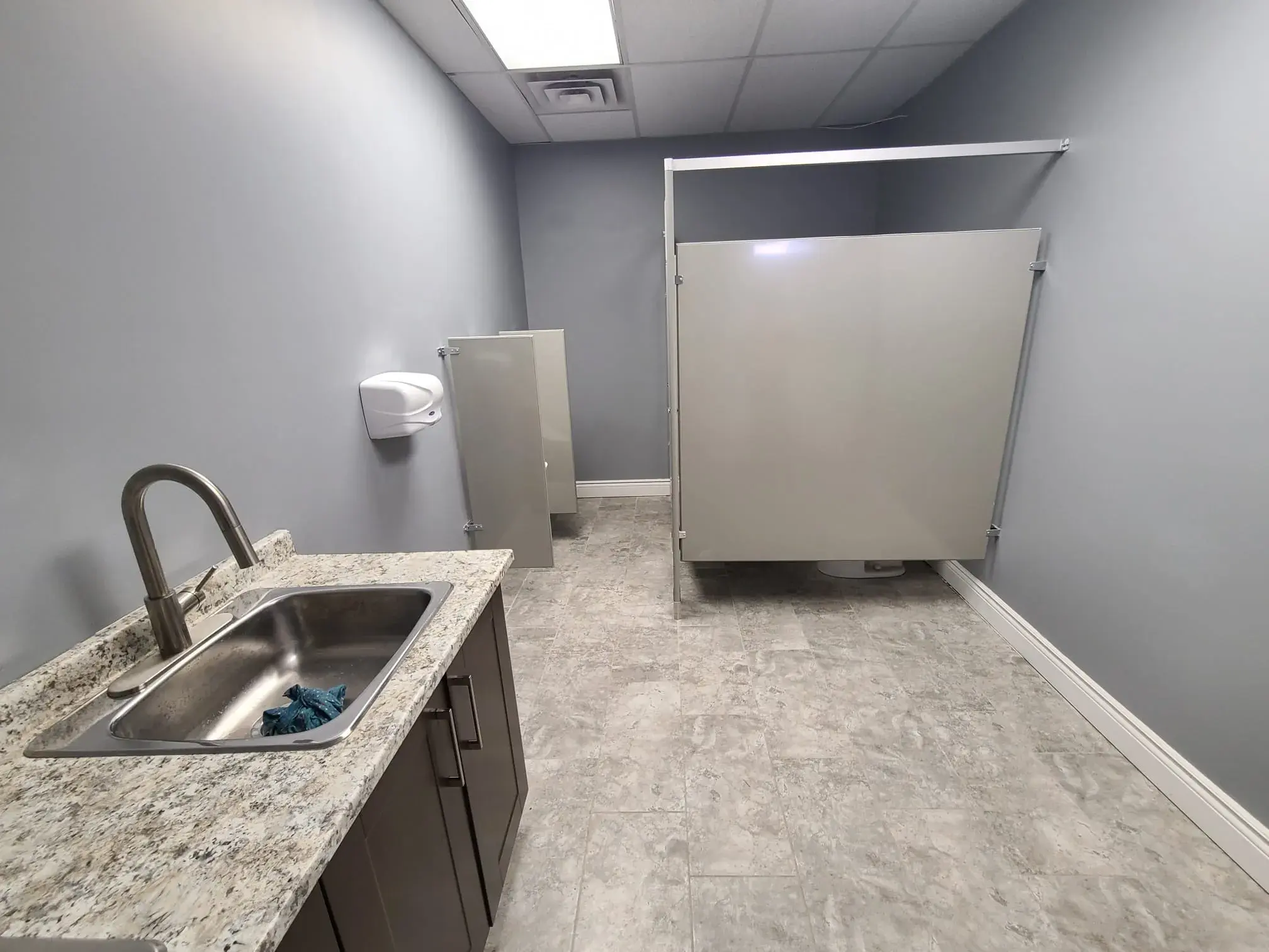Finished commercial bathroom conversion with bright clean tilework
